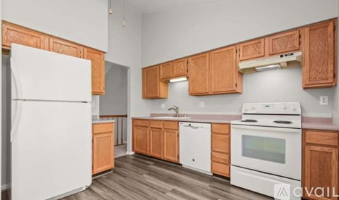 A kitchen with wooden cabinets and white appliances.