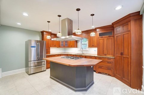 A kitchen with wooden cabinets and a central island.