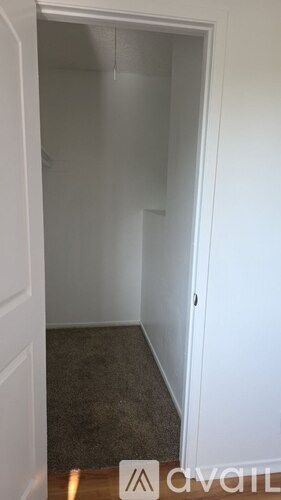 A white door with a sign on the floor.