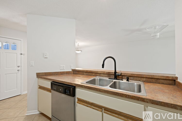 A kitchen with a sink and a dishwasher.