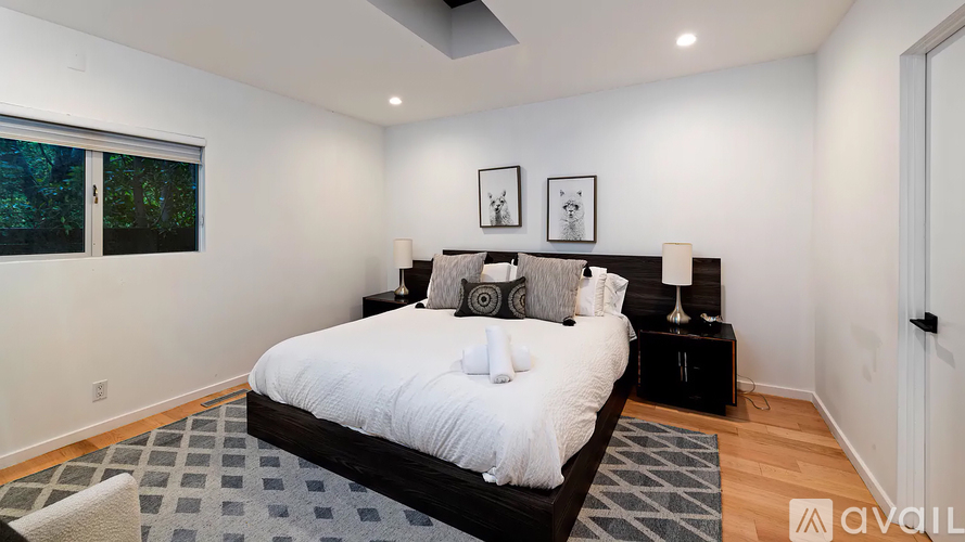 A bedroom with a large bed and a window.