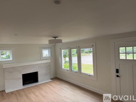 A living room with a fireplace and sliding glass doors.