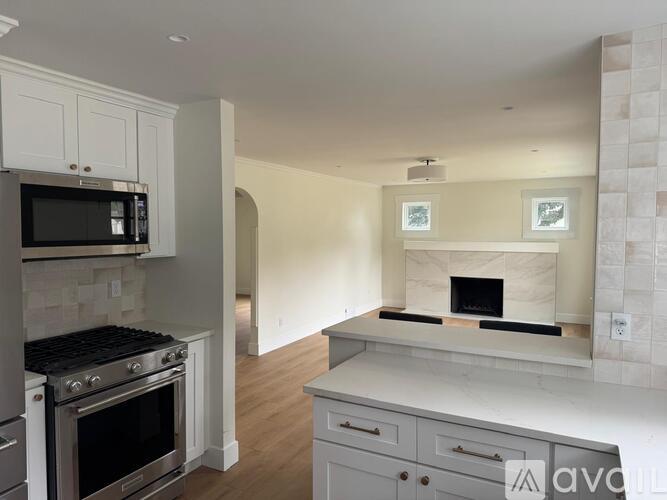 A kitchen with a stove top oven and a microwave above it.