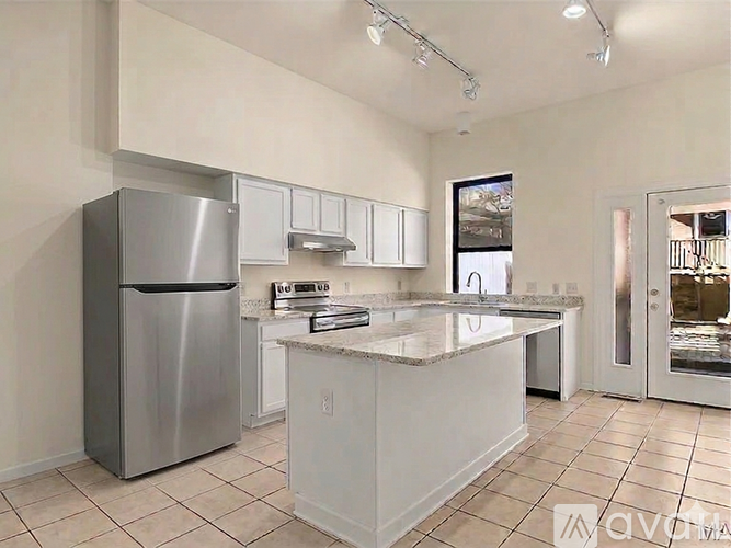 A kitchen with a refrigerator, stove, and oven.