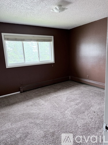 A room with brown walls and a window.