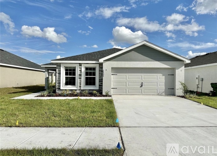 A house with a garage is for sale.