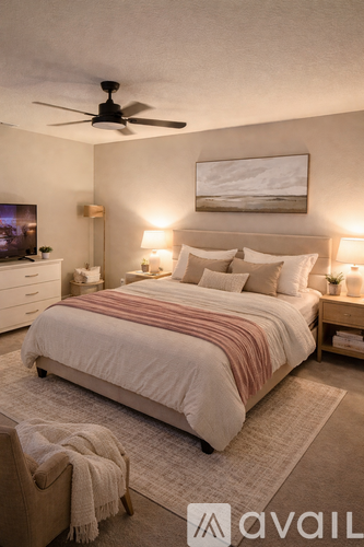 A bedroom with a large bed and a ceiling fan.