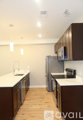 A kitchen with brown cabinets and a white counter.