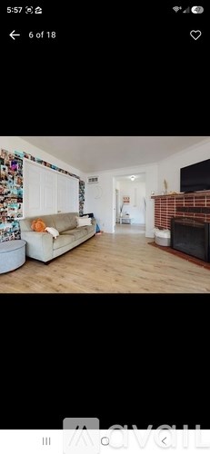 A living room with a couch and a fireplace.