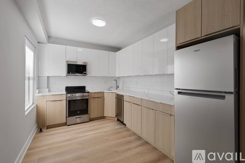 A kitchen with wooden cabinets and stainless steel appliances.