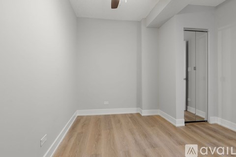 A room with wooden flooring and a white door.