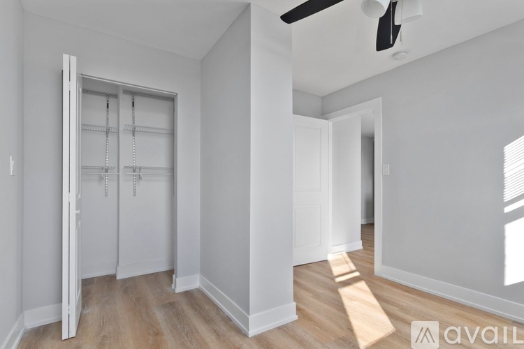 A room with a sliding door and a ceiling fan.