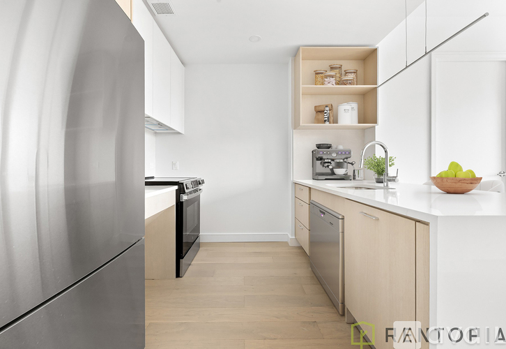 A modern kitchen with a stainless steel refrigerator and wooden cabinets.