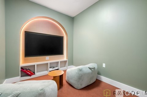 A modern living room with a television and comfortable seating.