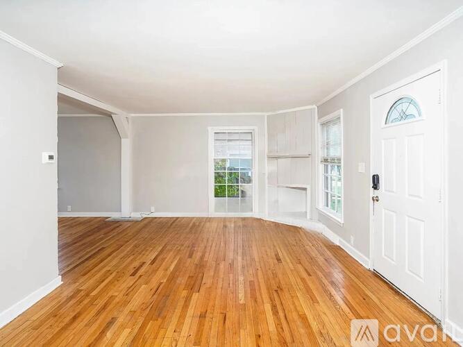 A room with wooden floors and white walls.
