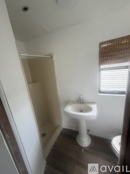 A small white sink in a small bathroom.