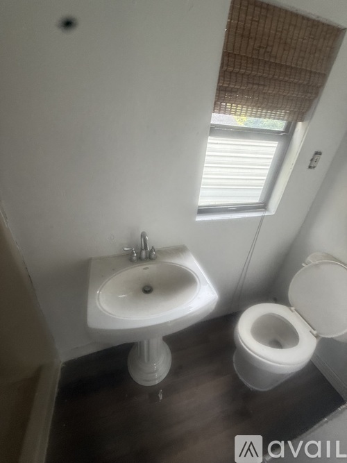A white sink and toilet in a small bathroom.