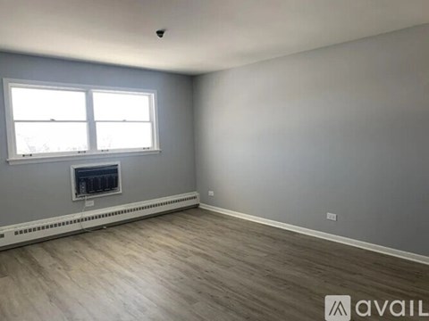 A room with a fireplace and a window.