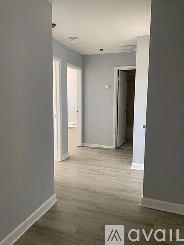 A room with a wooden floor and white walls.