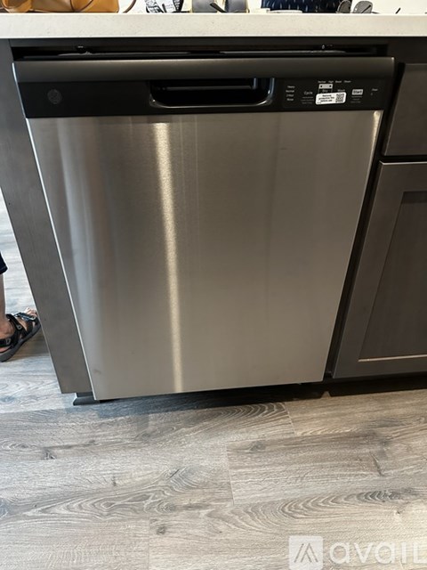 A stainless steel dishwasher is in a kitchen.