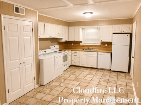 A kitchen with white appliances and cabinets, with the text "Cloudfire LLC Property Management" overlaid.
