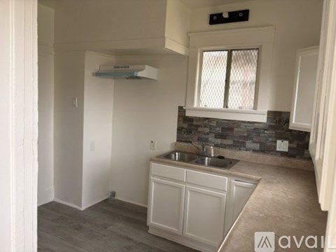 A kitchen with a sink and a window.
