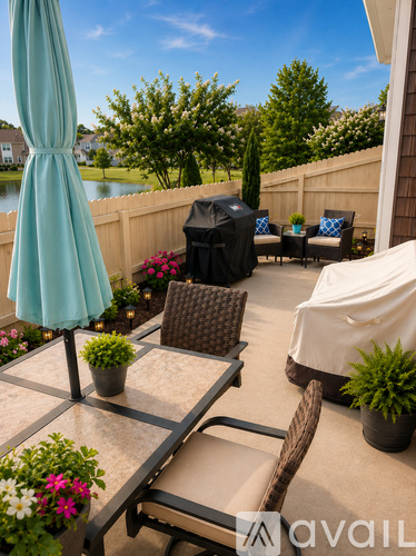A patio with a table, chairs, and an umbrella.