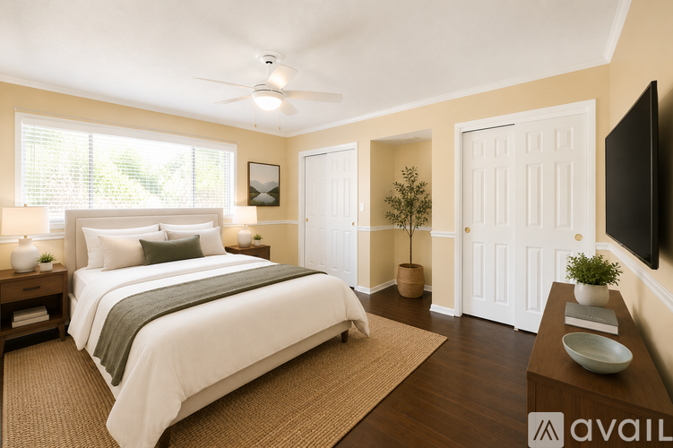 A bedroom with a large bed and a flat screen TV mounted on the wall.