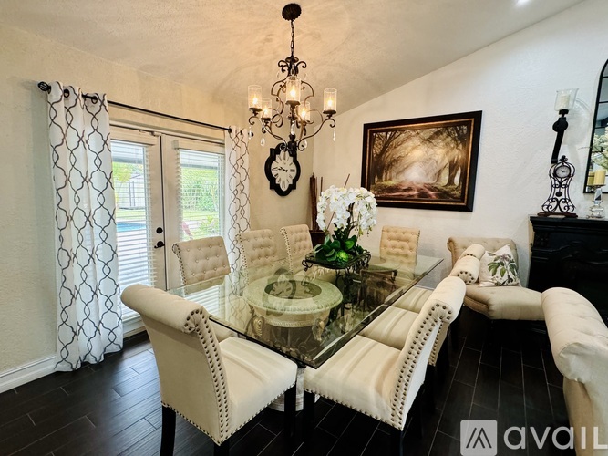 A dining room with a glass table and chairs.