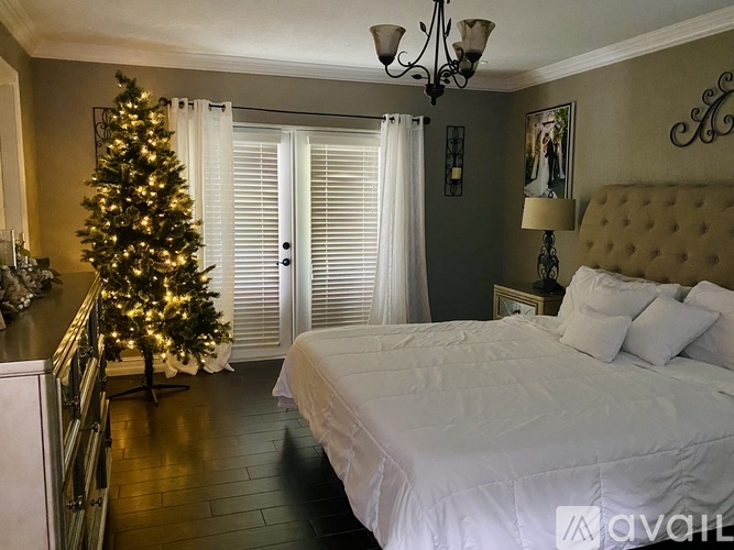 A bedroom with a Christmas tree and a bed.