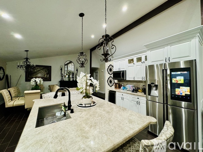 A kitchen with a sink and a refrigerator.