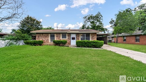 A house with a well-maintained lawn is for sale.