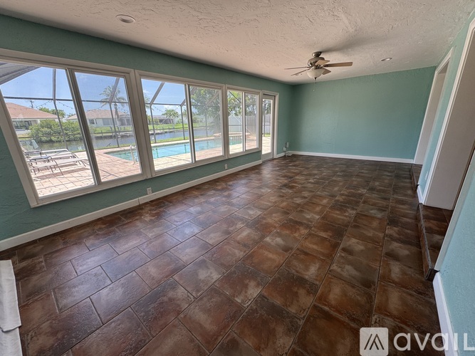 A room with a pool visible through the windows.