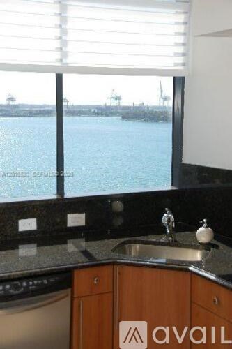 A kitchen with a view of the water.
