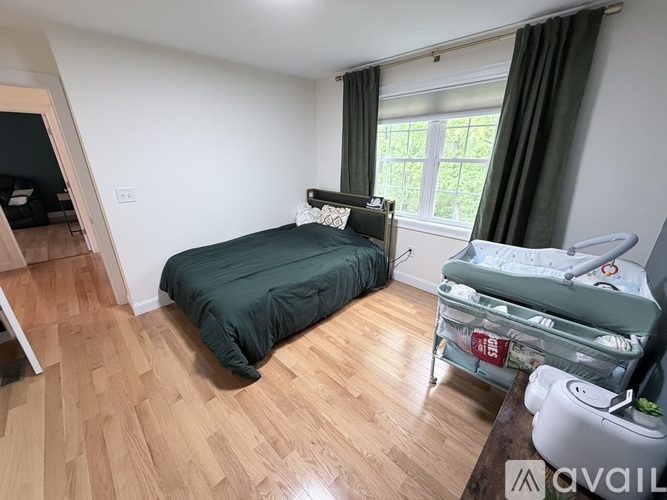 A bedroom with a bed and a crib.