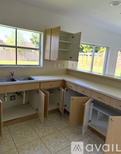 A kitchen with a sink and cabinets.