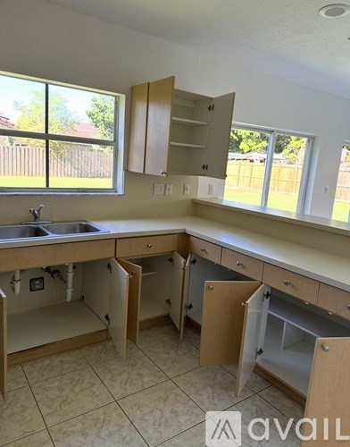 A kitchen with a sink and cabinets.