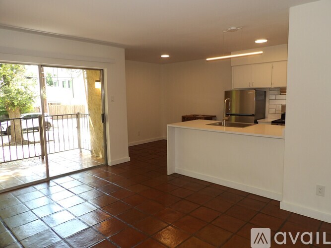 A kitchen area with a refrigerator, microwave, and oven.