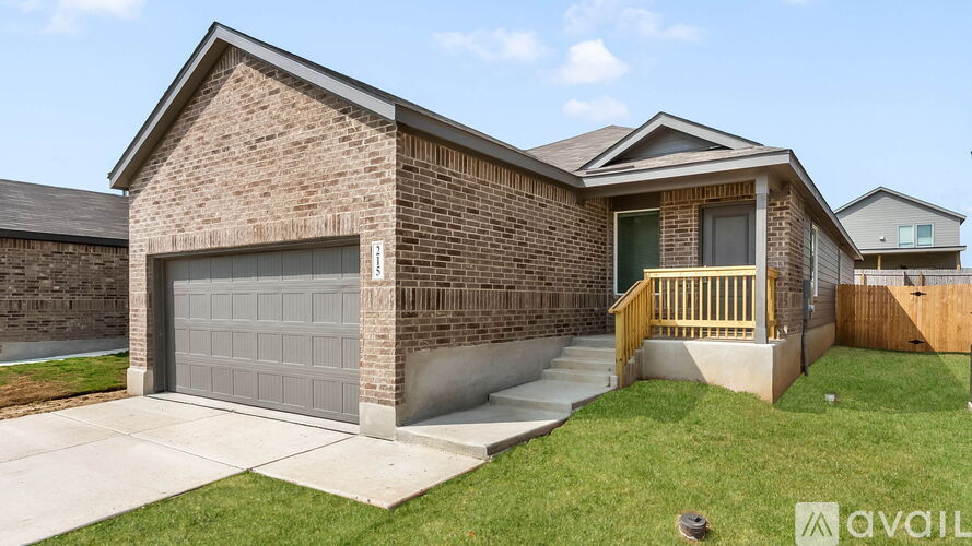 A house with a brick facade and a grey garage door.
