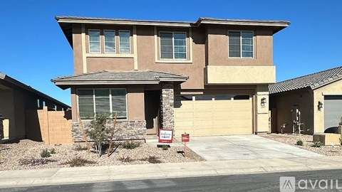 A house with a garage and a driveway is for sale.