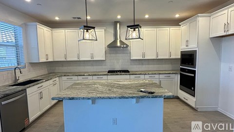 A kitchen with a blue island in the middle.