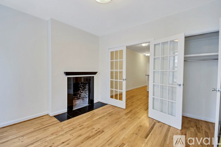 A room with a fireplace and wooden floors.