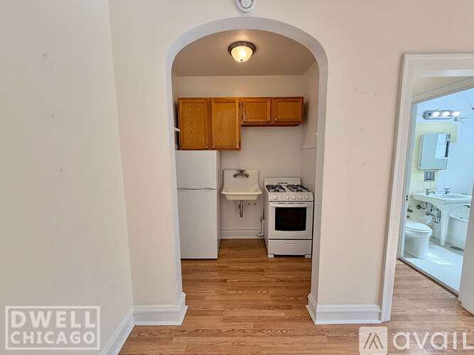 A kitchen with white appliances and wooden cabinets is shown.