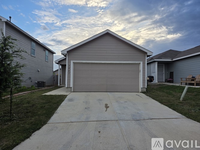 A house with a garage door is for sale.