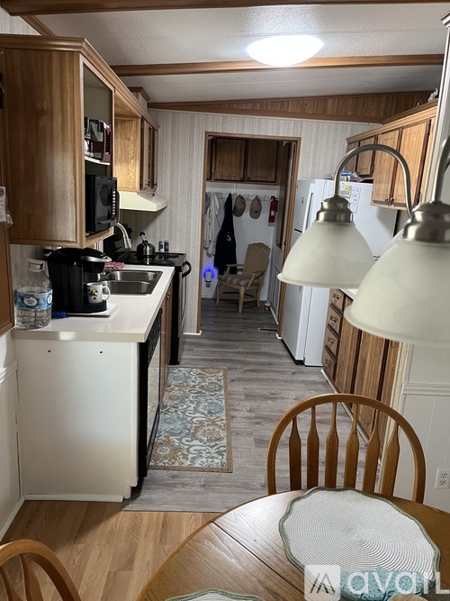 A kitchen with wooden cabinets and a white fridge.