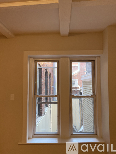 A window with a view of a building outside.