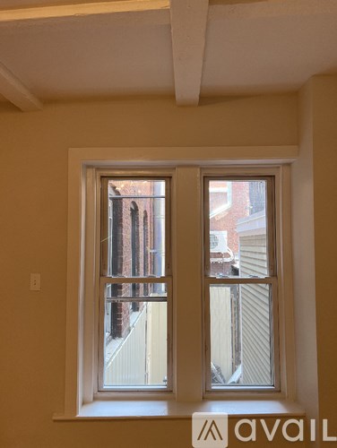A window with a view of a building outside.