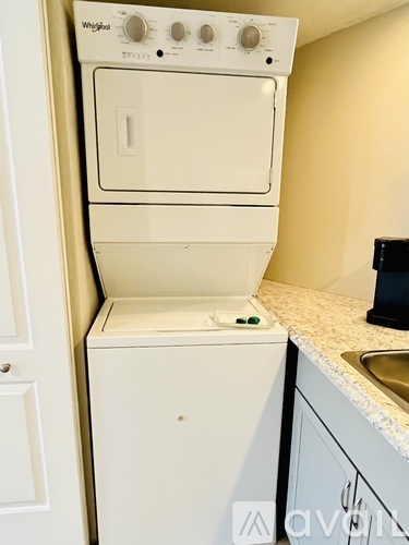 A white Whirlpool dishwasher is in a kitchen.