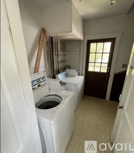 A small laundry room with a washer and dryer.