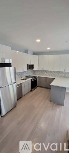 A kitchen with a refrigerator, stove, and oven.
